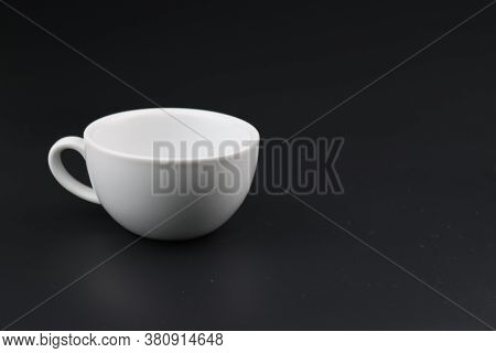 Empty white coffee cup on black color background
