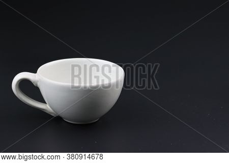 Empty white coffee cup on black color background