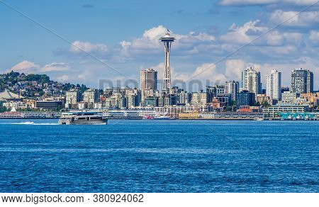 A Water Taxi Cruises Toware The Skyline In Seattle, Washington.