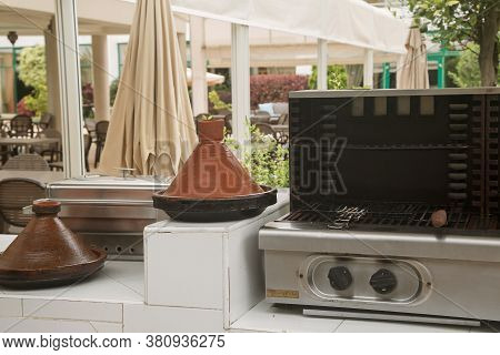 Traditional Moroccan Pottery Called Tagine And Grill With Coals, Photo Taken In A Hotel In Morocco