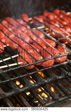 Sausages With Ground Beef Are Cooked On Coals. High Quality Photo