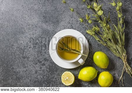 White Cup Of Herbal Sage Tea With Dried Sage Leaves And Lemon On Grey Rustic Background. Herbal Tea 
