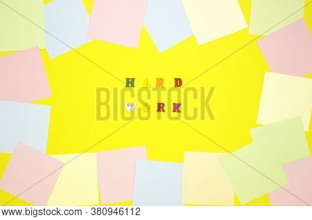 The Concept Of Motivation, Work. The Words Hard Work In The Center On A Yellow Background, Colored L
