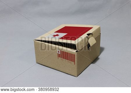 Tongan Flag On Brown Box With Barcode And The Color Of Tonga Flag, Paper Packaging For Put Products.