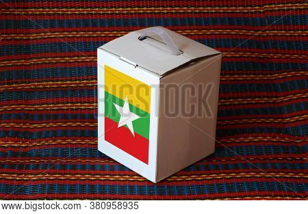 Myanmese Flag On White Box With Stripe Background, Paper Packaging For Put Products. The Concept Of 