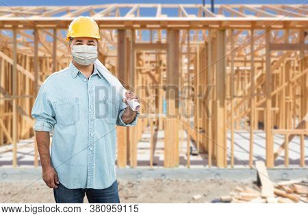 Male Contractor In Hard Hat Wearing Medical Face Mask During Coronavirus Pandemic At Construction Site.