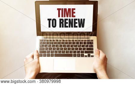 Young Man Checking His Laptop, Top View. Text Time To Renew