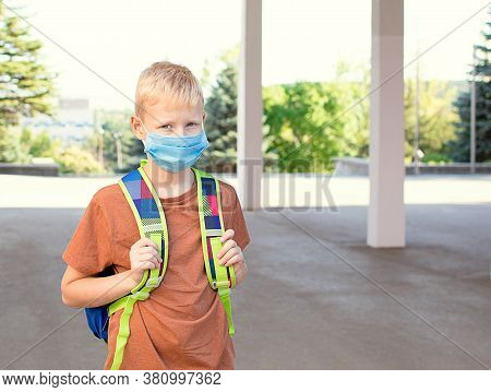 Back To School. School-age Boy With A Protective Medical Mask On Her On His Face With A School Backp