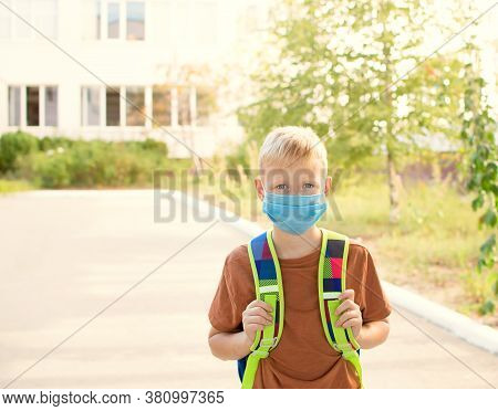 Back To School. School-age Boy With A Protective Medical Mask On Her On His Face With A School Backp