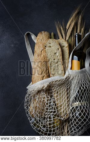 Homemade Italian Bread Baguette Stirato And A Bottle Of Wine In A Shopping Bag