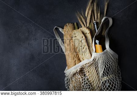 Homemade Italian Bread Baguette Stirato And A Bottle Of Wine In A Shopping Bag