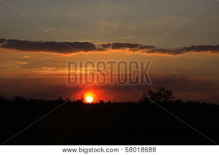 Sun Rays And Dark Clouds At Sunset