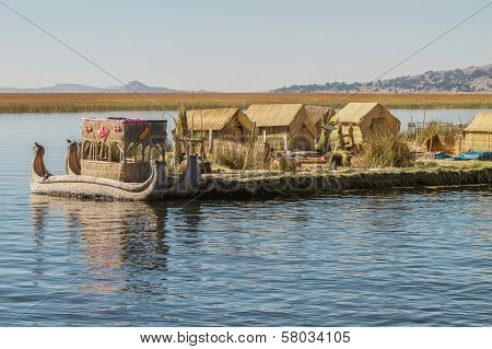 iew of floating island Uros Lake Titicaca Peru Bolivia and reed boat with its reflection.