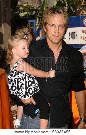 Larry Birkhead and daughter Dannielynn Smith  at the Grand Opening of 