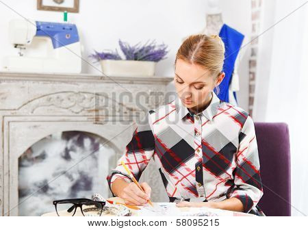 Dressmaker Is Drawing A Fashion Sketch