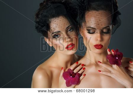 Craving. Aspiration. Two Seductive Fervent Women With Flowers