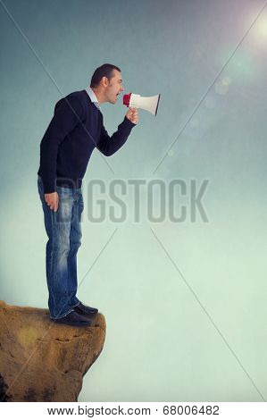 Man With Megaphone Shouting From Cliff Edge