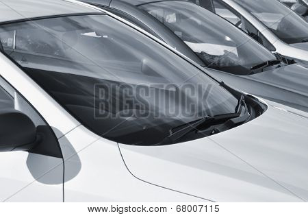 Telephoto view of parked cars in car park (toned blue)