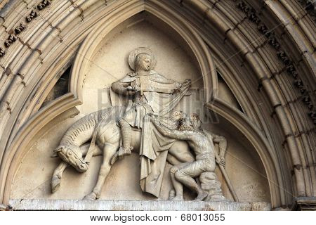 PARIS, FRANCE - NOV 11, 2012: Saint Martin of Tours, tympanum of St Severin Church. It is one of the oldest churches on the Left Bank situated in the Latin Quarter.