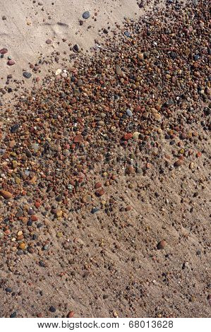 Wet sand and pebbles on Baltic beach near Ustka, Poland. Natural background.