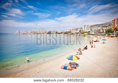 SARANDA, ALBANIA - JUNE 08, 2014: Unidentified tourists on pablic beach on  June 08, 2014 in Saranda, Albania. Saranda is one of the most important and most popular resorts on the Albanian coast.