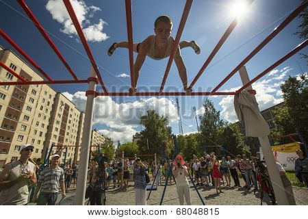 TIKHVIN, RUSSIA - JULY 7, 2014: Unidentified participants city competitions in Street workout timed to the celebration of the day of the city of Tikhvin.