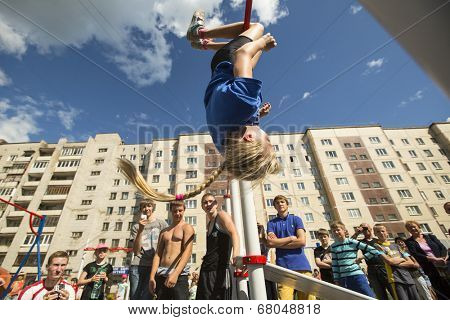 TIKHVIN, RUSSIA - JULY 7, 2014: Unidentified participants city competitions in Street workout timed to the celebration of the day of the city of Tikhvin.