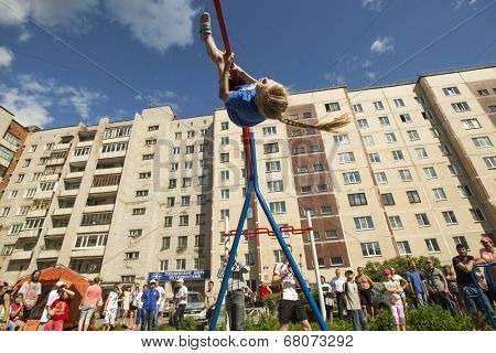 TIKHVIN, RUSSIA - JULY 7, 2014: Unidentified participants city competitions in Street workout timed to the celebration of the day of the city of Tikhvin.