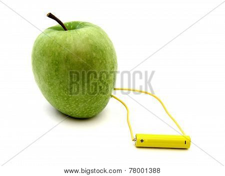 Green Apple Connected To A Battery