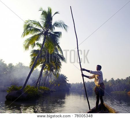 Indian boatman and traditional boat.