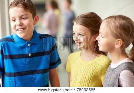 education, elementary school, children, break and people concept - group of smiling school kids talking in corridor