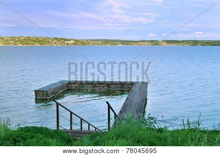 Stairs Down To Wooden Pier At Great River Kama In Evening Summer