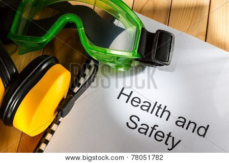 Register With Goggles And Earphones On Wooden Background