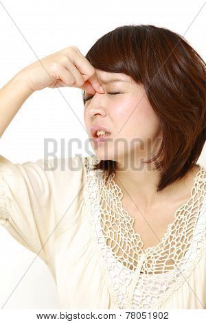portrait of young Japanese woman suffers from Asthenopia