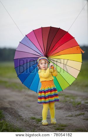 girl with rainbow umrella in the field