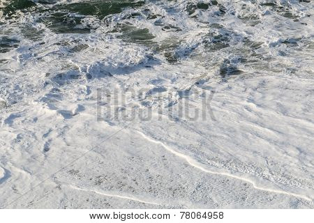 Waves And Backwash On A Sandy Beach