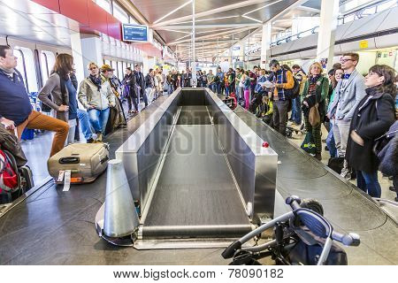 People Wait At Baggage Belt  In  Tegel Airport