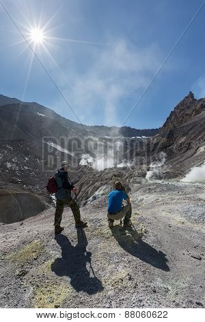 Tourists In Active Crater Mutnovsky Volcano On Kamchatka. Russia