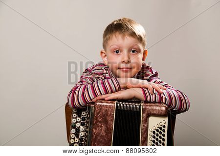 The Boy Crossed His Arms And Leaned On The Accordion