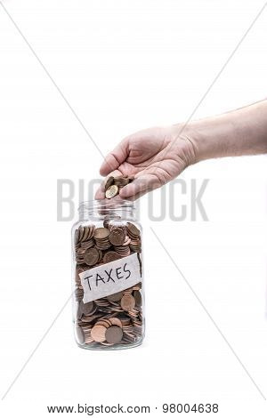 Jar labeled Taxes being fileld with British pennys