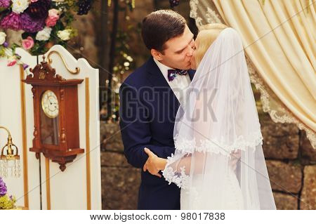 Wonderful Stylish Rich Happy Bride And Groom Higing Kissing At A Wedding Ceremony In  Garden