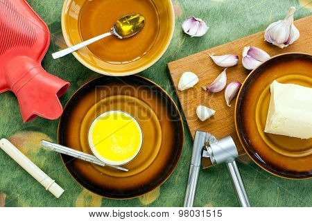 home made remedy for flu: glass of hot milk with honey butter and garlic