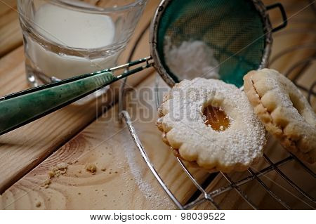 Biscuits with appricot marmalade with glass of milk