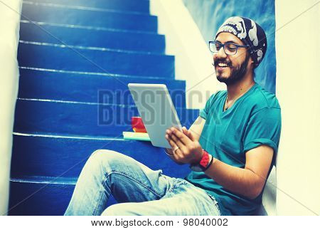 Sikh Guy Browsing Tablet Stair Case Concept