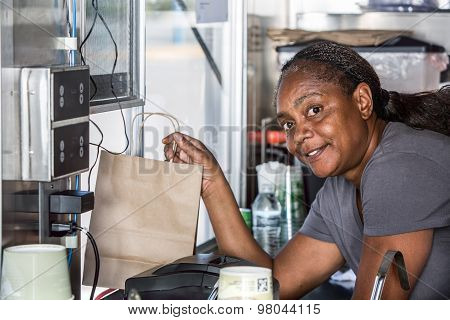 Smiling African-american Worker Hands Food Order Out Window
