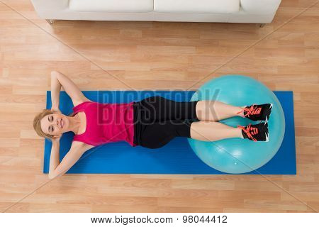 Woman Exercising With Pilates Ball