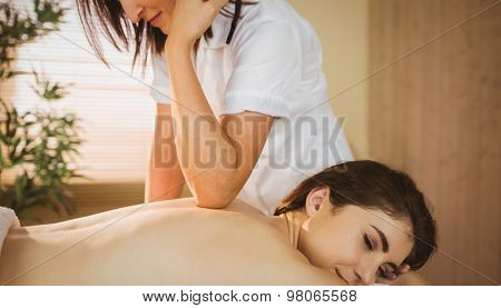 Young woman getting a massage in therapy room