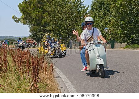Couple Riding Vintage Scooter Vespa