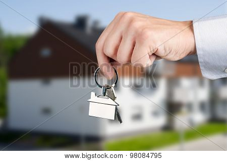 Man Hand Holding Keys With To New House