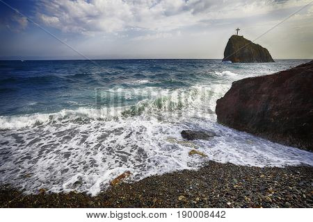 Sea waves crashing on the shore and flowing above seashore pebbles. spindrift